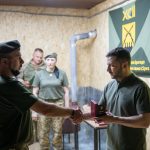 In this handout photograph taken and released by the Ukrainian Presidential Press Service on August 4, 2025, Ukraine's President Volodymyr Zelensky (R) presents a medal to a Ukrainian serviceman of the 92nd Separate Assault Brigade on the frontline positions at an undisclosed location in the Kharkiv region, amid the Russian invasion of Ukraine. President Volodymyr Zelensky said on August 4, 2025 that he had visited Ukrainian troops holding the line in the Kharkiv region bordering Russia and discussed how drones were used in fighting. (Photo by Handout / UKRAINIAN PRESIDENTIAL PRESS SERVICE / AFP) / RESTRICTED TO EDITORIAL USE - MANDATORY CREDIT "AFP PHOTO / UKRAINIAN PRESIDENTIAL PRESS SERVICE" - NO MARKETING NO ADVERTISING CAMPAIGNS - DISTRIBUTED AS A SERVICE TO CLIENTS