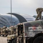 US soldiers work on their vehicles at a temporary base installed close to the Rzeszow-Jasionka Airport, south eastern Poland, February 16, 2022. Dozens of US paratroopers landed at Rzeszow Airport in Poland -- part of a deployment of several thousand sent to bolster NATO's eastern flank in response to tensions with Russia. (Photo by Wojtek RADWANSKI / AFP) (Photo by WOJTEK RADWANSKI/AFP via Getty Images)